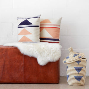 Modern Throw Pillows in Blush, Blue, and Coral on Leather Bench