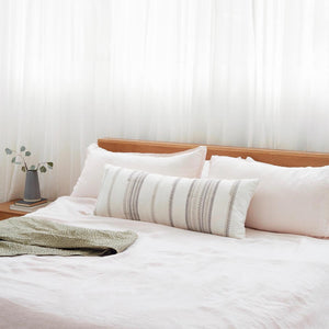 Striped Lumbar with Block Print Design on Bed with Green Quilt