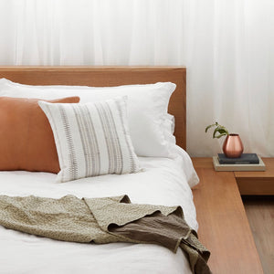 Cotton and Leather Accent Pillows on Bed with Kantha Quilt